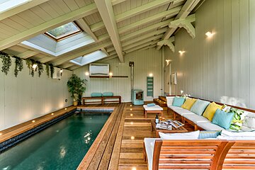 A room with a swimming pool and a couch