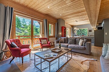 A living room with a couch and two chairs