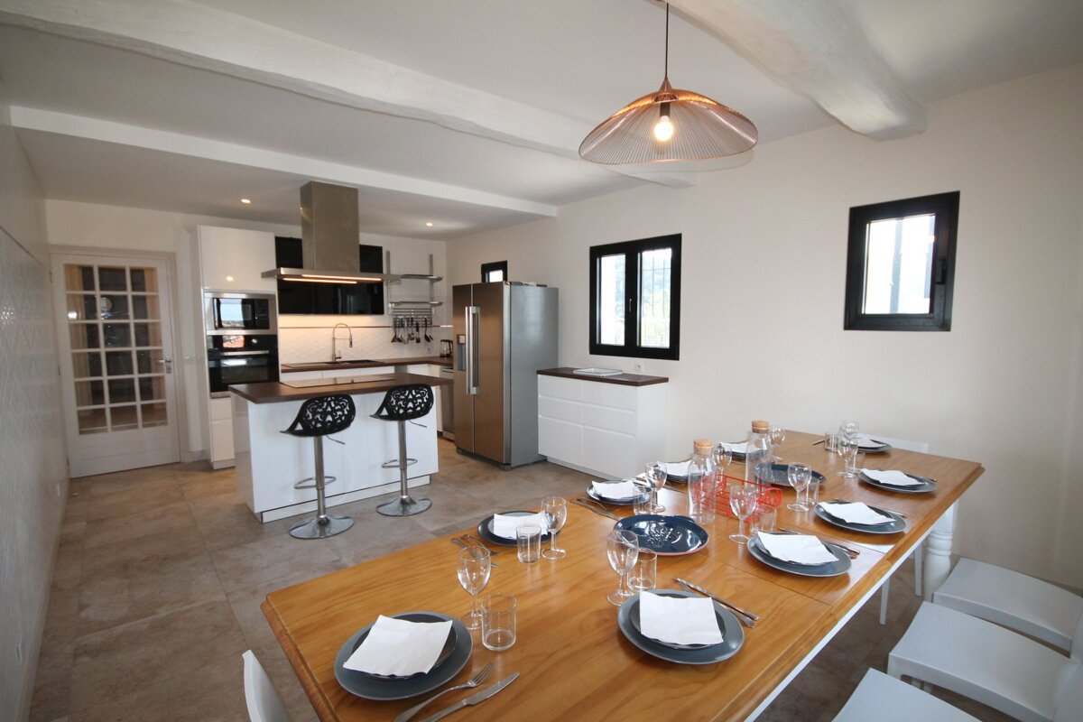 A dining room table with plates and glasses on it