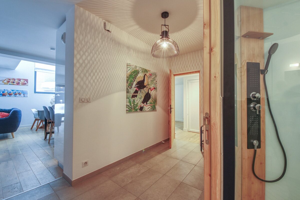 A hallway with a painting of toucans on the wall