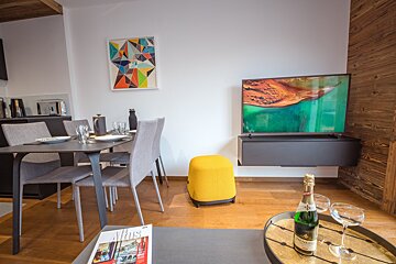 A bottle of champagne sits on a tray in a living room