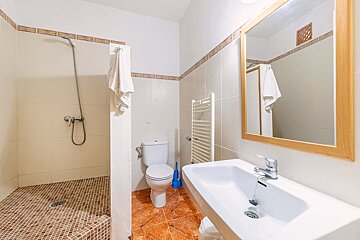 A bathroom with a toilet a sink and a mirror