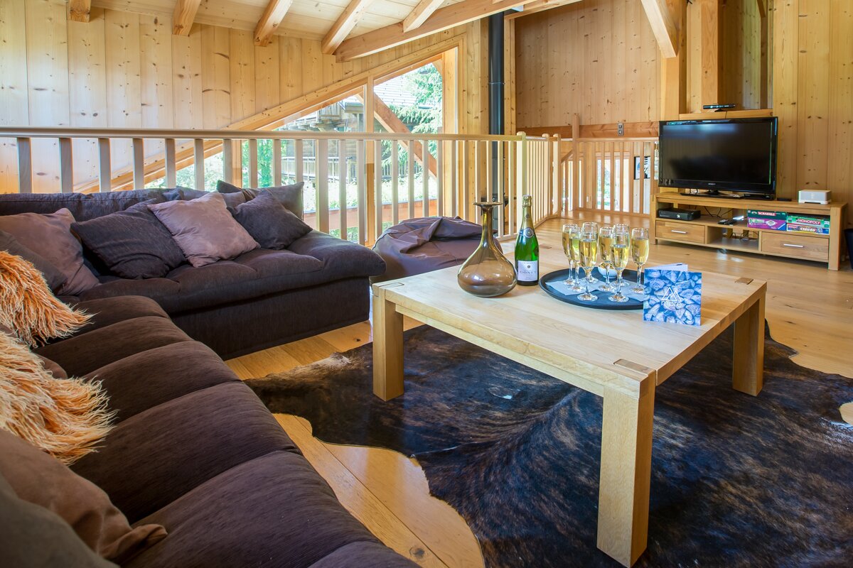A bottle of champagne sits on a table in a living room
