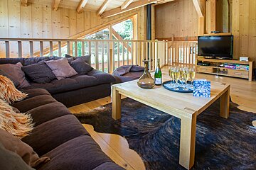 A bottle of champagne sits on a table in a living room