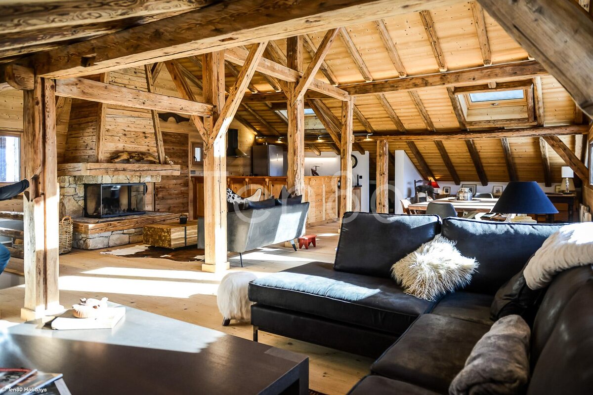 A living room with a couch and chairs and a fireplace