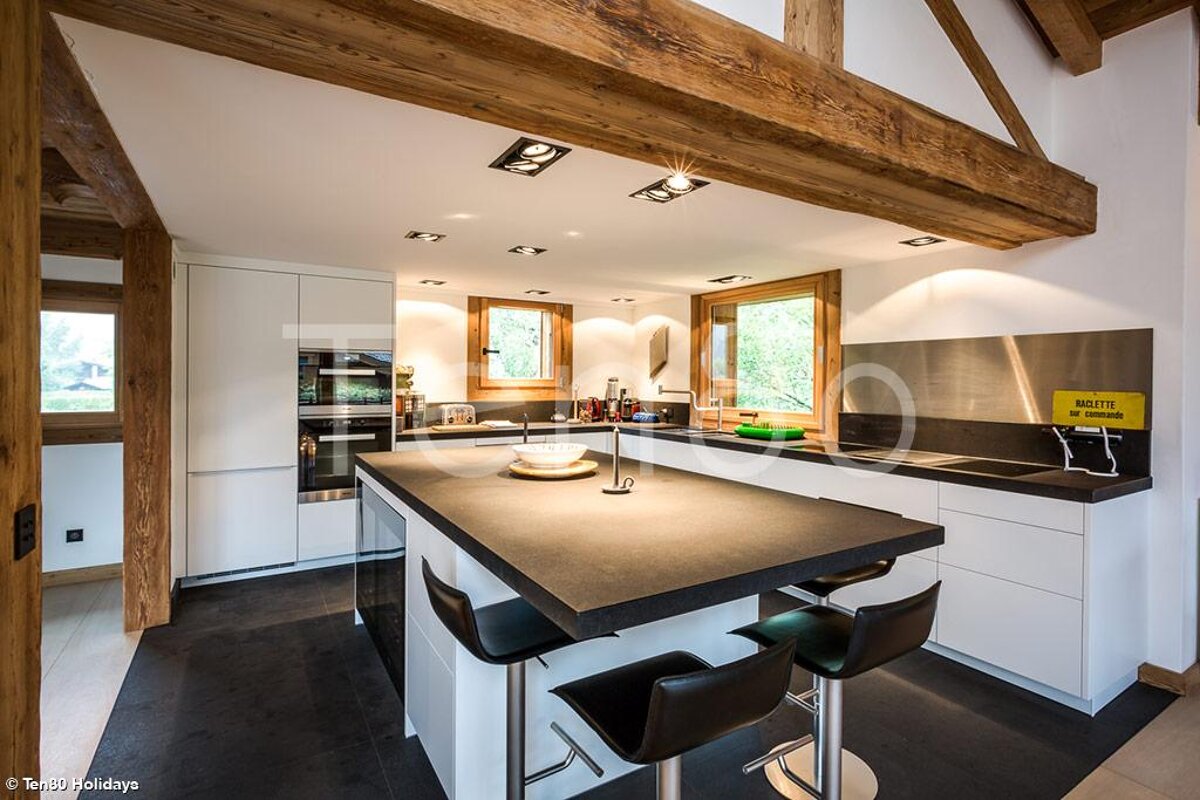 A kitchen with a stainless steel counter top and a yellow sign that says