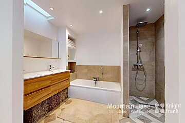 A bathroom with a bathtub and a shower with knight frank written on the bottom