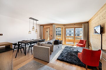 A living room with a couch a chair and a table