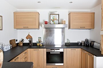 A kitchen with stainless steel appliances and wooden cabinets