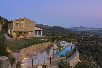A large house with a swimming pool in front of it
