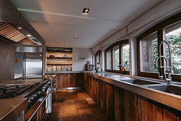 A kitchen with stainless steel appliances and wooden cabinets
