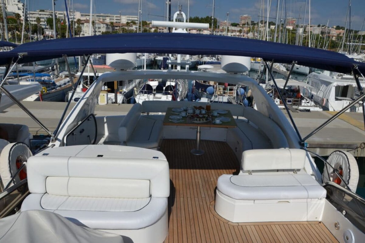 A boat with a table and chairs on the deck