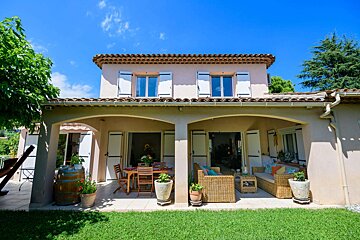 A house with a patio and a table and chairs on it