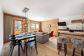 A living room with a dining table and chairs