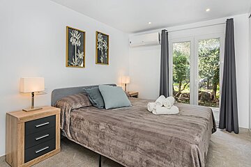 A bedroom with a large bed and two nightstands
