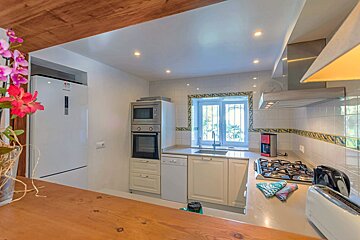 A kitchen with white cabinets and a samsung refrigerator