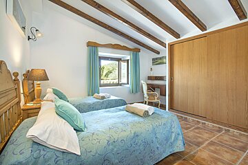 A bedroom with two beds and a sliding closet