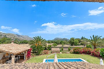 A house with a pool and mountains in the background