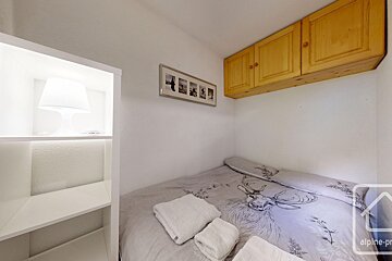 A small bedroom with a bed with a deer on it