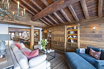 A living room with a blue couch and a white couch