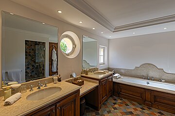 A bathroom with two sinks and a bathtub