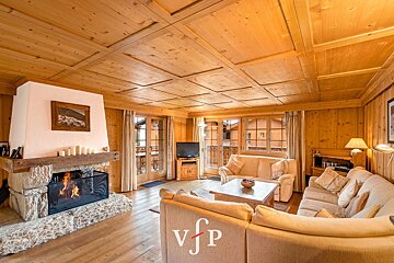 A living room with a fireplace and a vjp logo