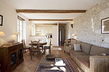 A living room with a couch a table and chairs