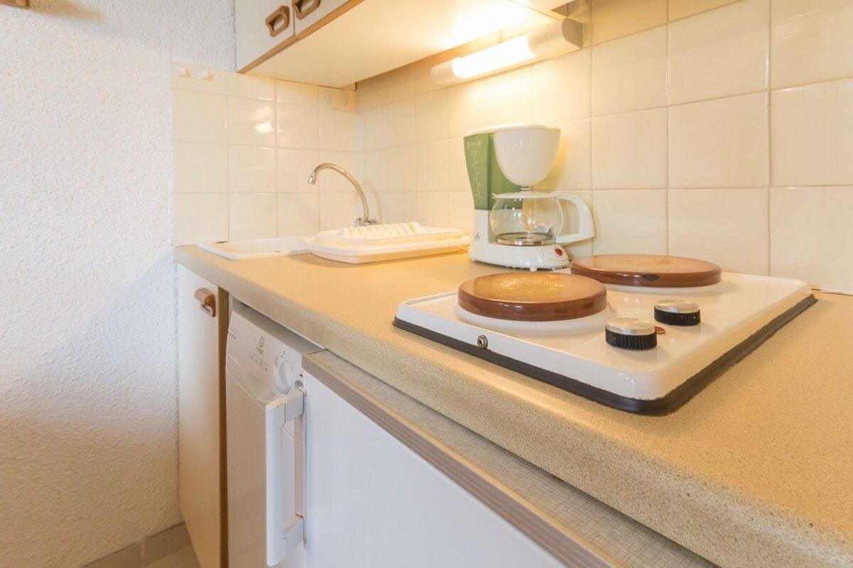 A kitchen counter with a coffee maker on it