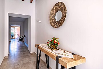 A wooden table with a vase of flowers on it