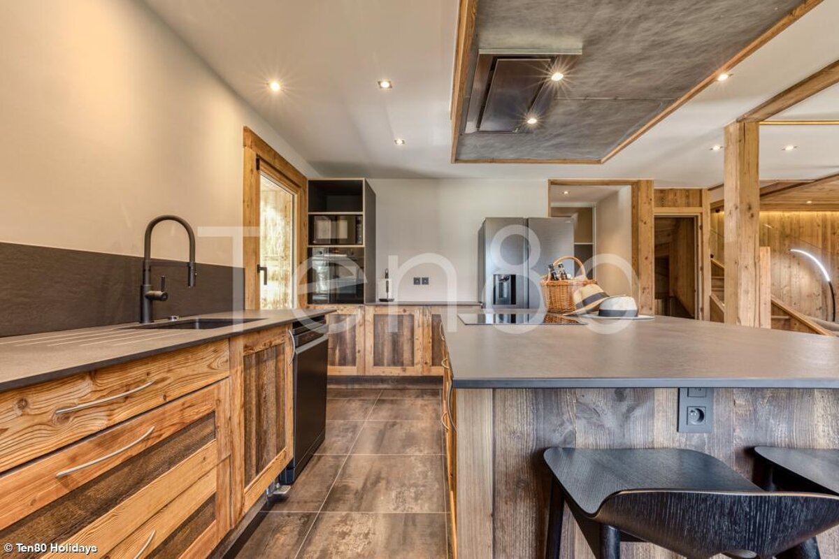 A kitchen with wooden cabinets and a black counter top