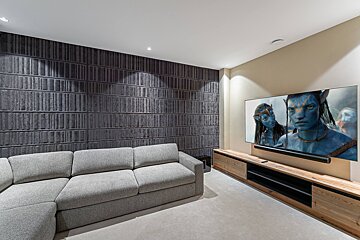 A room with wooden walls and shelves and a wooden bench