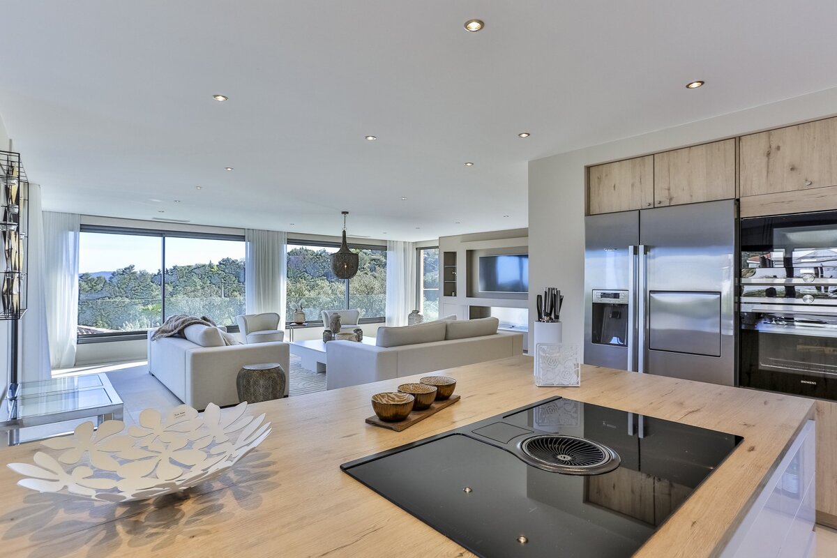 A kitchen with a stove top oven and a stainless steel refrigerator