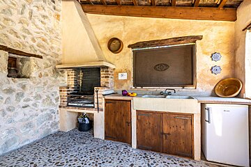 A kitchen with a sink and a candy refrigerator