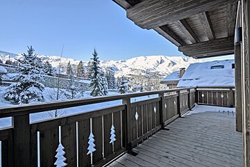 A balcony with a view of snow covered mountains