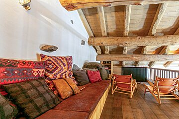 A couch with a lot of pillows on it