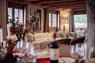 A bottle of wine sits on a table in a living room