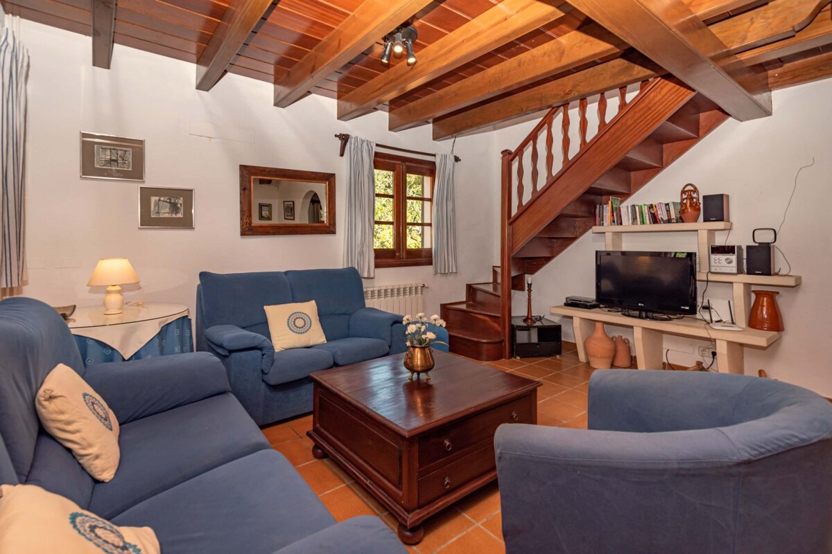 A living room with a staircase leading up to the second floor