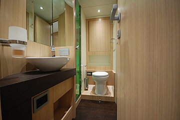 A bathroom with a toilet a sink and a mirror