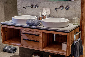 A bathroom with two sinks and a towel that says mount