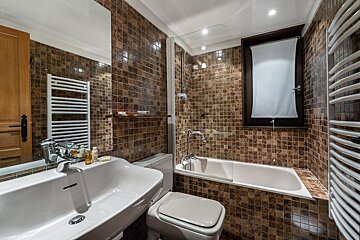 A bathroom with a sink toilet and bathtub