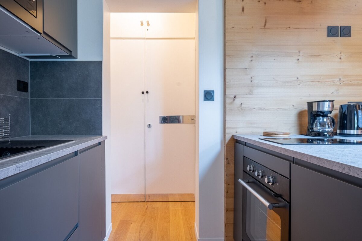 A kitchen with a coffee maker on the counter