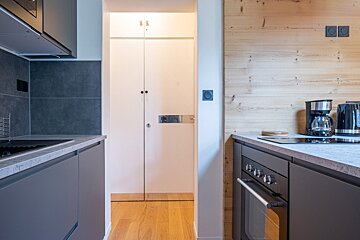 A kitchen with a coffee maker on the counter