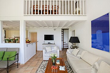 A living room with a couch a chair and a tv