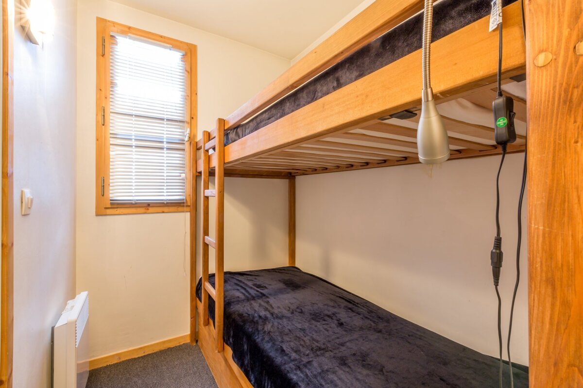 A bunk bed with a black blanket on it
