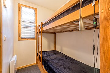 A bunk bed with a black blanket on it
