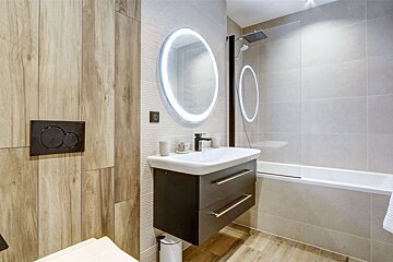 A bathroom with a sink a toilet and a shower