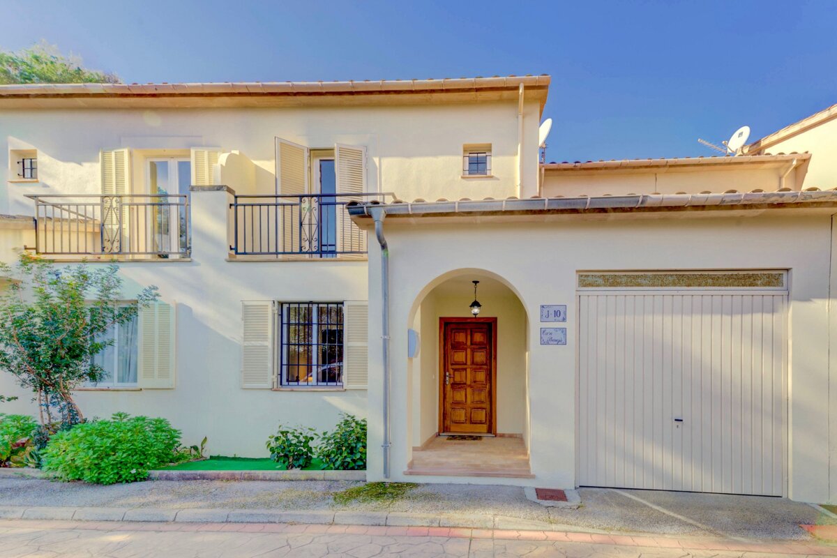 A white house with the number 18 on the garage door