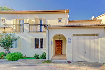 A white house with the number 18 on the garage door