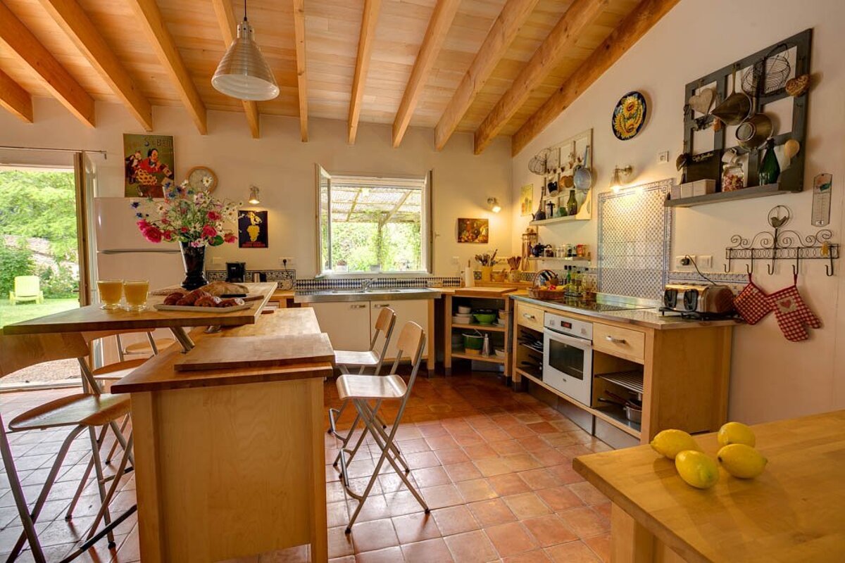 A kitchen with a table and chairs and a refrigerator