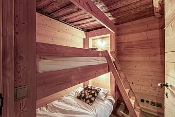 A bunk bed with a ladder leading up to it